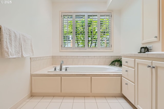 full bathroom with tile patterned floors, a bath, and vanity