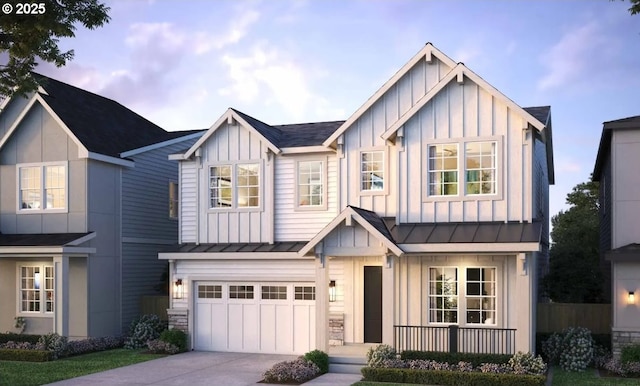 modern inspired farmhouse with driveway, board and batten siding, an attached garage, and a standing seam roof