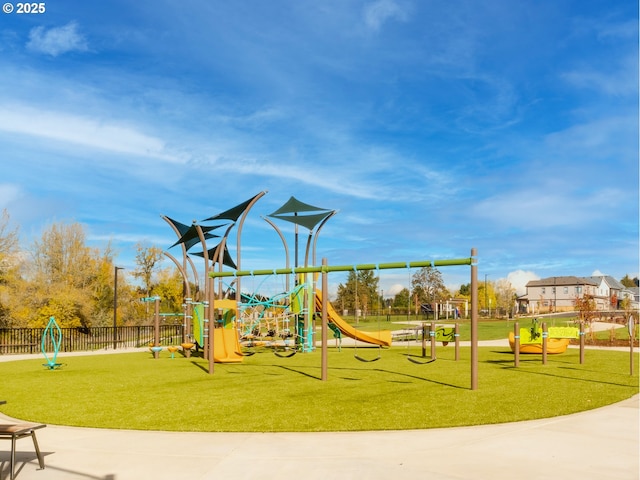 communal playground with fence and a lawn