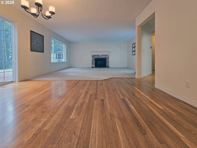 unfurnished living room with hardwood / wood-style floors and a chandelier