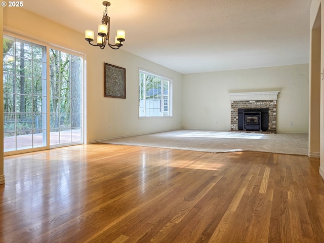 unfurnished living room with hardwood / wood-style flooring and a notable chandelier