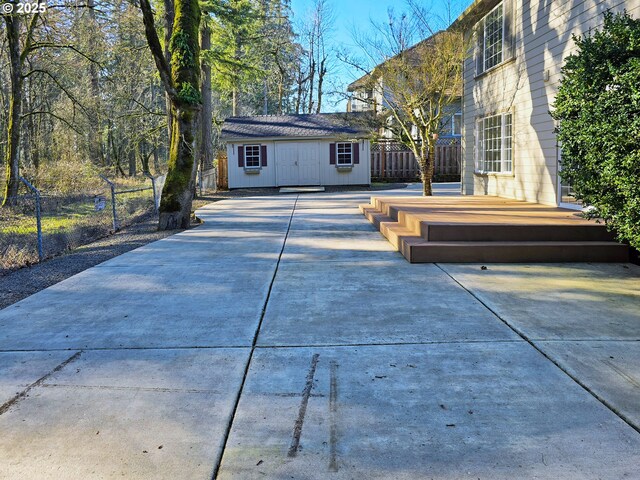 rear view of house with a wooden deck and an outbuilding