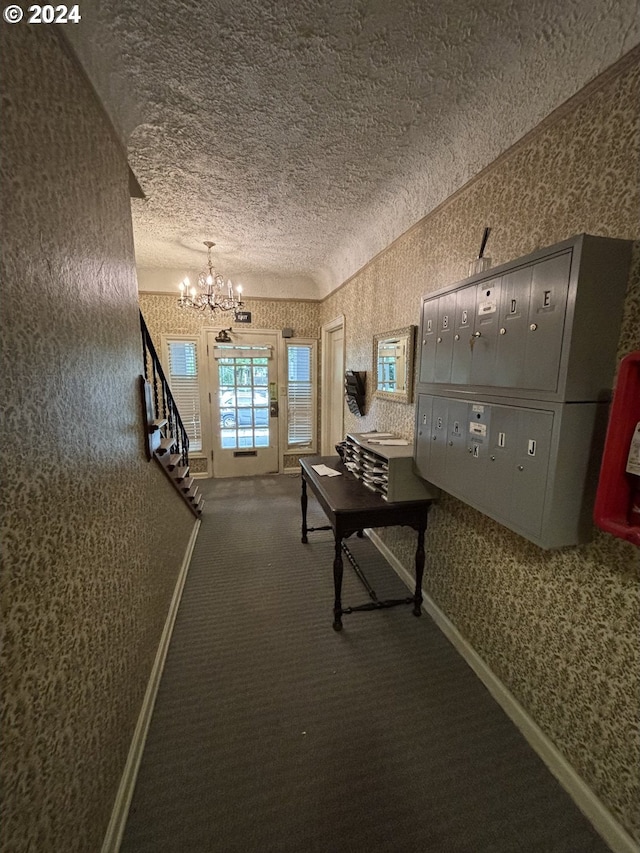 646 SE 60th Ave, Portland, OR 97215 - hallway with an inviting chandelier, carpet, a textured ceiling, and wallpapered walls