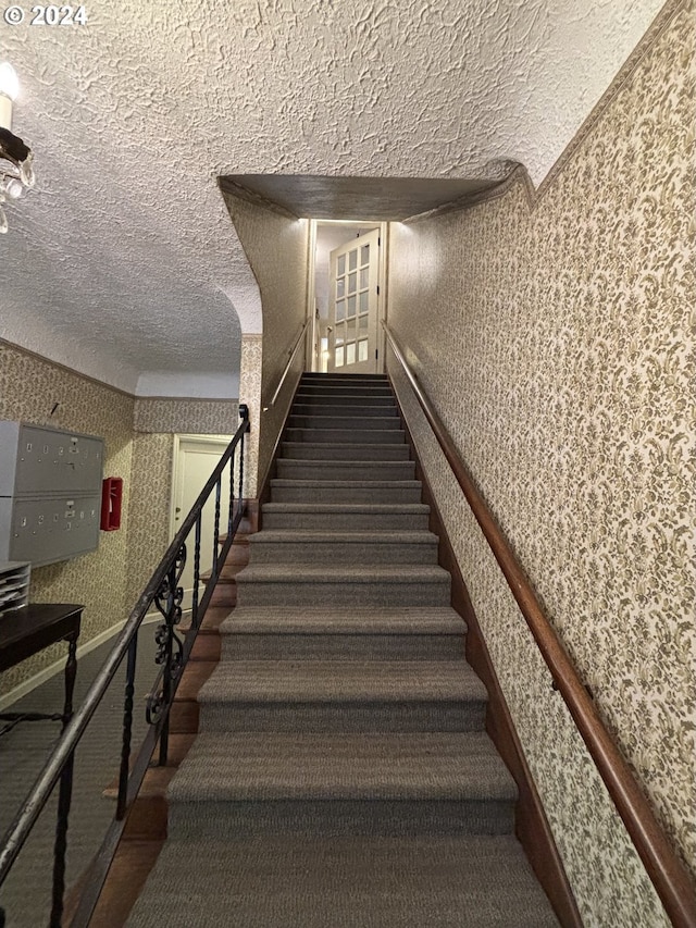 646 SE 60th Ave, Portland, OR 97215 - stairs with a textured ceiling and wallpapered walls