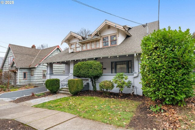 646 SE 60th Ave, Portland, OR 97215 - view of front of property with roof with shingles and a front lawn