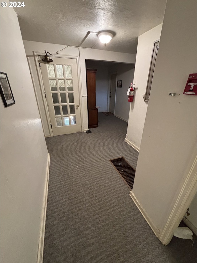 646 SE 60th Ave, Portland, OR 97215 - corridor with carpet floors, a textured ceiling, visible vents, and baseboards