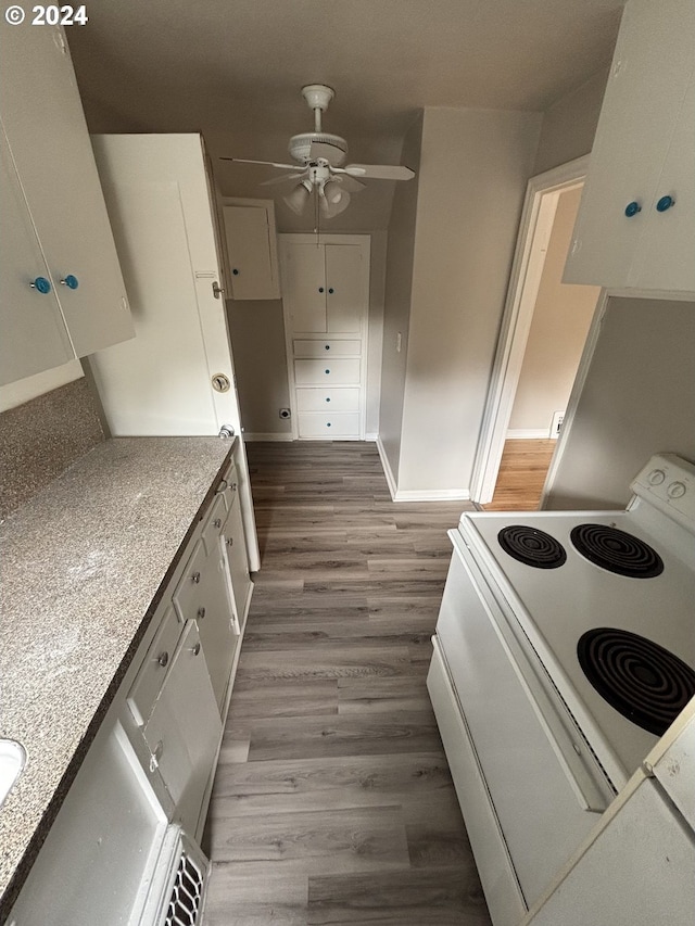 646 SE 60th Ave, Portland, OR 97215 - kitchen with a ceiling fan, baseboards, white cabinetry, wood finished floors, and white electric stove