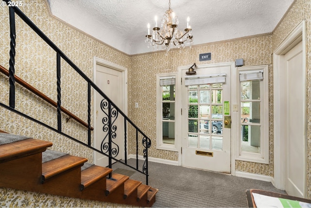 646 SE 60th Ave, Portland, OR 97215 - entryway featuring a textured ceiling, a chandelier, carpet, wallpapered walls, and stairway