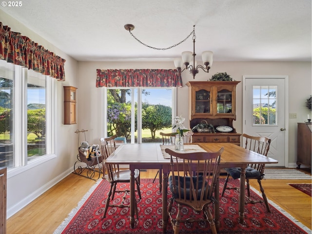 13513 SE 132nd Ave, Clackamas, OR 97015 - dining area with healthy amount of natural light, a chandelier, and light wood-type flooring