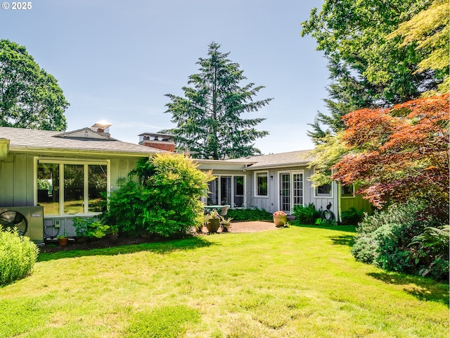 13513 SE 132nd Ave, Clackamas, OR 97015 - back of property featuring board and batten siding, a yard, and a chimney
