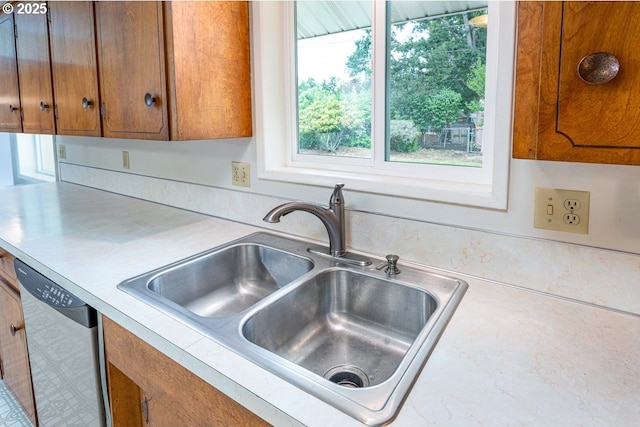 965 Robin Hood Ave, Eugene, OR 97401 - kitchen featuring stainless steel dishwasher, light countertops, and brown cabinetry