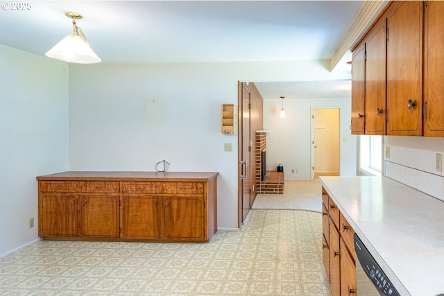 965 Robin Hood Ave, Eugene, OR 97401 - kitchen featuring brown cabinets, stainless steel dishwasher, light countertops, and hanging light fixtures