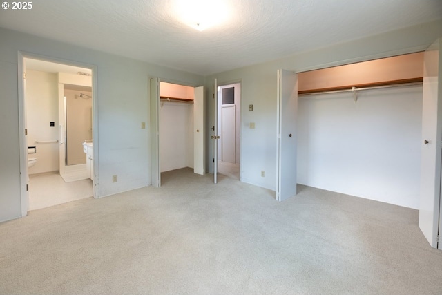 965 Robin Hood Ave, Eugene, OR 97401 - unfurnished bedroom featuring two closets, light colored carpet, and connected bathroom