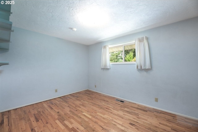 965 Robin Hood Ave, Eugene, OR 97401 - empty room with wood finished floors and a textured ceiling