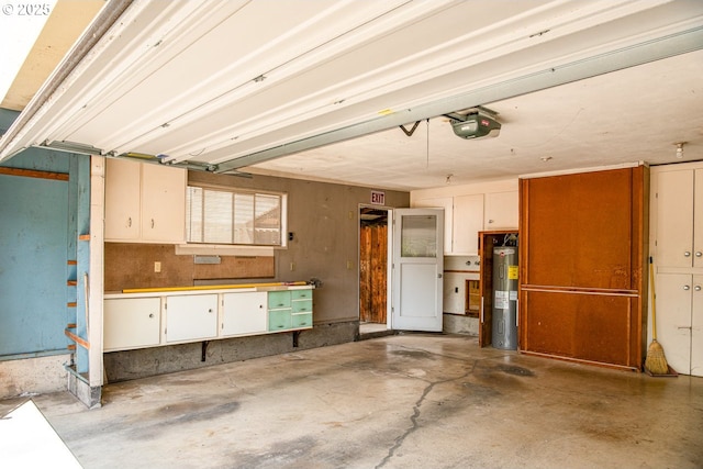 965 Robin Hood Ave, Eugene, OR 97401 - garage with electric water heater, a garage door opener, and a workshop area