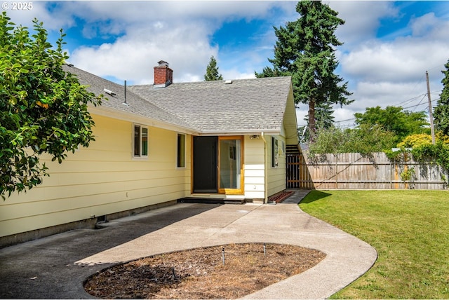 965 Robin Hood Ave, Eugene, OR 97401 - view of front facade with a shingled roof, a patio area, and a chimney