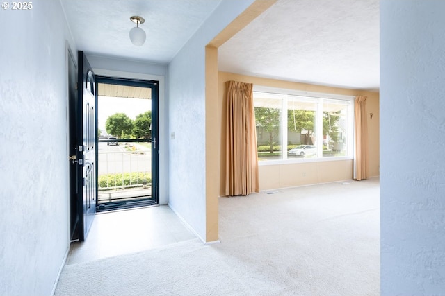 965 Robin Hood Ave, Eugene, OR 97401 - carpeted entrance foyer with a textured wall and plenty of natural light
