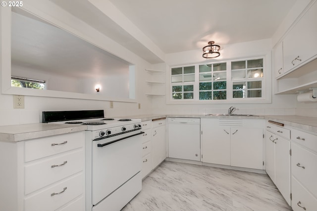 kitchen featuring white cabinetry, sink, and white appliances