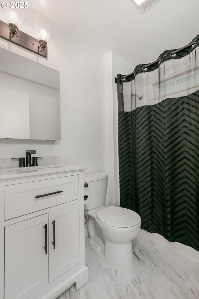 bathroom with vanity, toilet, and curtained shower