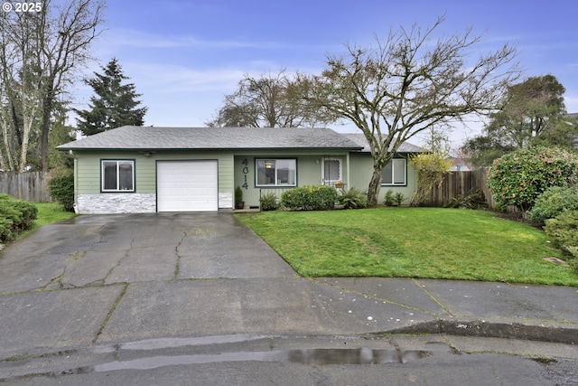 ranch-style house with an attached garage, driveway, a front lawn, and fence