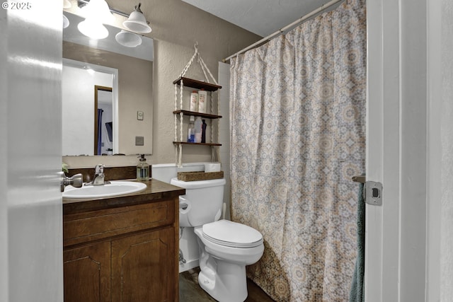 full bath featuring vanity, a shower with shower curtain, toilet, and a textured wall