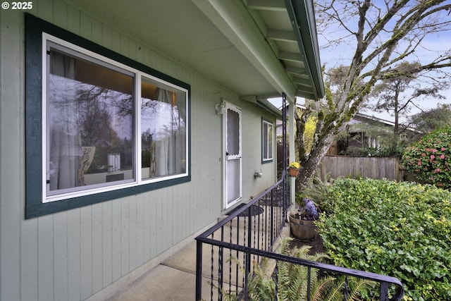 view of side of home featuring fence