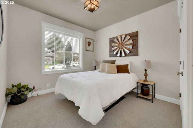 bedroom with baseboards and carpet flooring