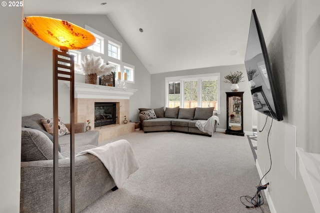 carpeted living area featuring baseboards, plenty of natural light, high vaulted ceiling, and a fireplace