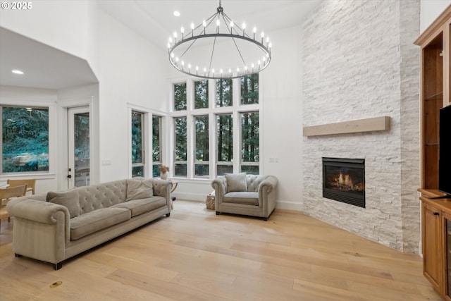 9423 NE 180th Way, Battle Ground, WA 98604 - living area featuring a towering ceiling, a fireplace, light wood-style flooring, a chandelier, and recessed lighting