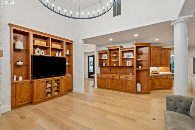 9423 NE 180th Way, Battle Ground, WA 98604 - living area with light wood finished floors, ornate columns, a towering ceiling, recessed lighting, and baseboards