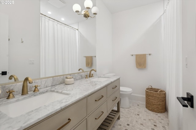9423 NE 180th Way, Battle Ground, WA 98604 - bathroom featuring double vanity, toilet, baseboards, and a shower with shower curtain