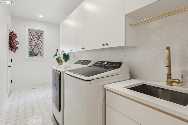 9423 NE 180th Way, Battle Ground, WA 98604 - laundry room featuring washing machine and clothes dryer, cabinet space, baseboards, light flooring, and recessed lighting