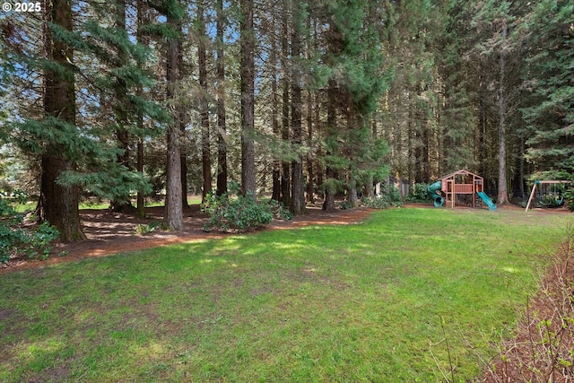 9423 NE 180th Way, Battle Ground, WA 98604 - view of grassy yard featuring a playground and a wooded view
