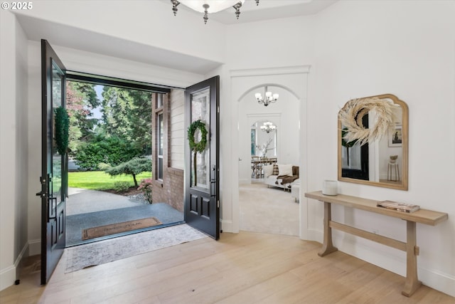 9423 NE 180th Way, Battle Ground, WA 98604 - entryway featuring a chandelier, wood finished floors, arched walkways, and baseboards