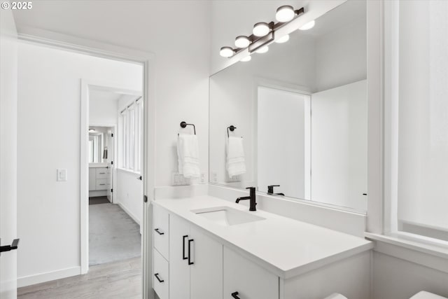 1375 N Wygant St, Portland, OR 97217 - bathroom featuring vanity, wood finished floors, toilet, and baseboards