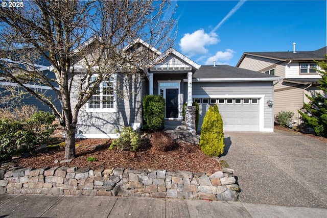 view of front of property featuring aphalt driveway and an attached garage