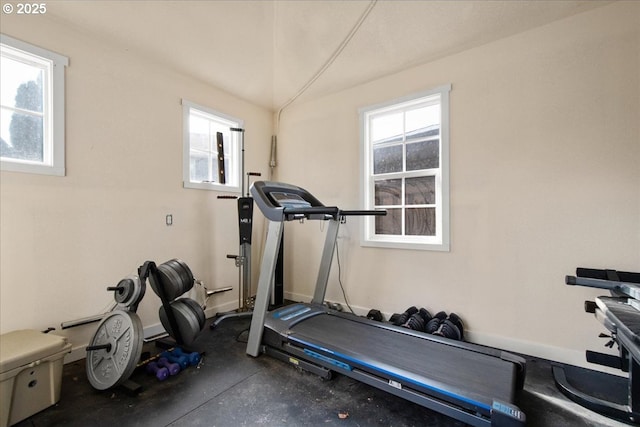 workout area with vaulted ceiling and baseboards