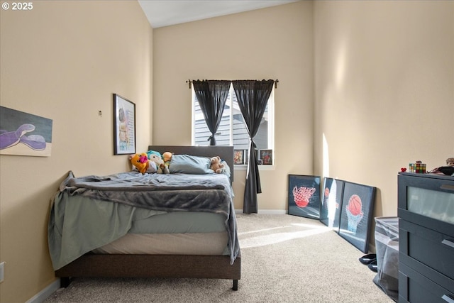 bedroom with baseboards and carpet