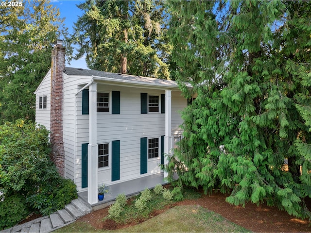 view of side of home featuring a chimney