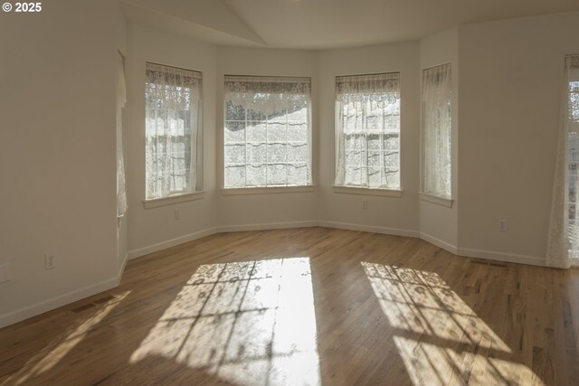 1985 32nd St, Florence, OR 97439 - empty room featuring visible vents, baseboards, and wood finished floors