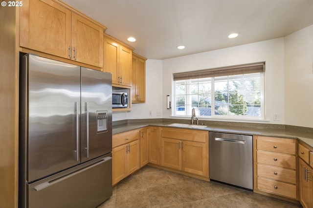 kitchen with stainless steel appliances, sink, and light tile patterned floors