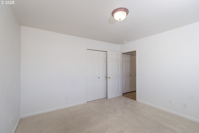 unfurnished room with light colored carpet