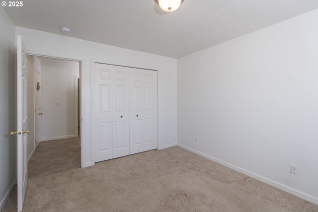1985 32nd St, Florence, OR 97439 - unfurnished bedroom with a closet, baseboards, and carpet floors