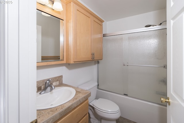 1985 32nd St, Florence, OR 97439 - bathroom featuring toilet, vanity, and shower / bath combination with glass door