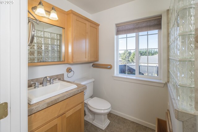 1985 32nd St, Florence, OR 97439 - bathroom with toilet, vanity, baseboards, and tile patterned flooring