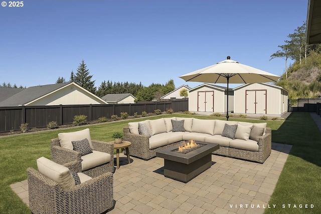 1985 32nd St, Florence, OR 97439 - view of patio / terrace featuring an outbuilding, a fenced backyard, an outdoor living space with a fire pit, and a storage unit