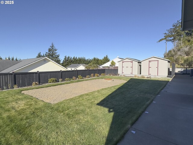 1985 32nd St, Florence, OR 97439 - view of yard with an outbuilding, a storage unit, and a fenced backyard