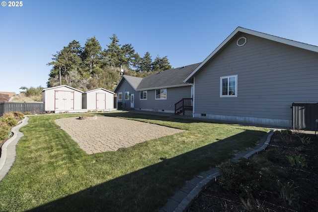 rear view of house featuring a shed, a yard, and a patio area