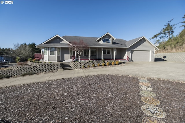 1985 32nd St, Florence, OR 97439 - view of front of home featuring an attached garage, covered porch, and concrete driveway