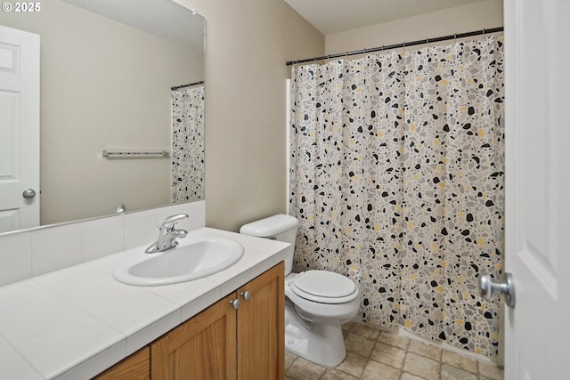 bathroom with vanity, toilet, and curtained shower